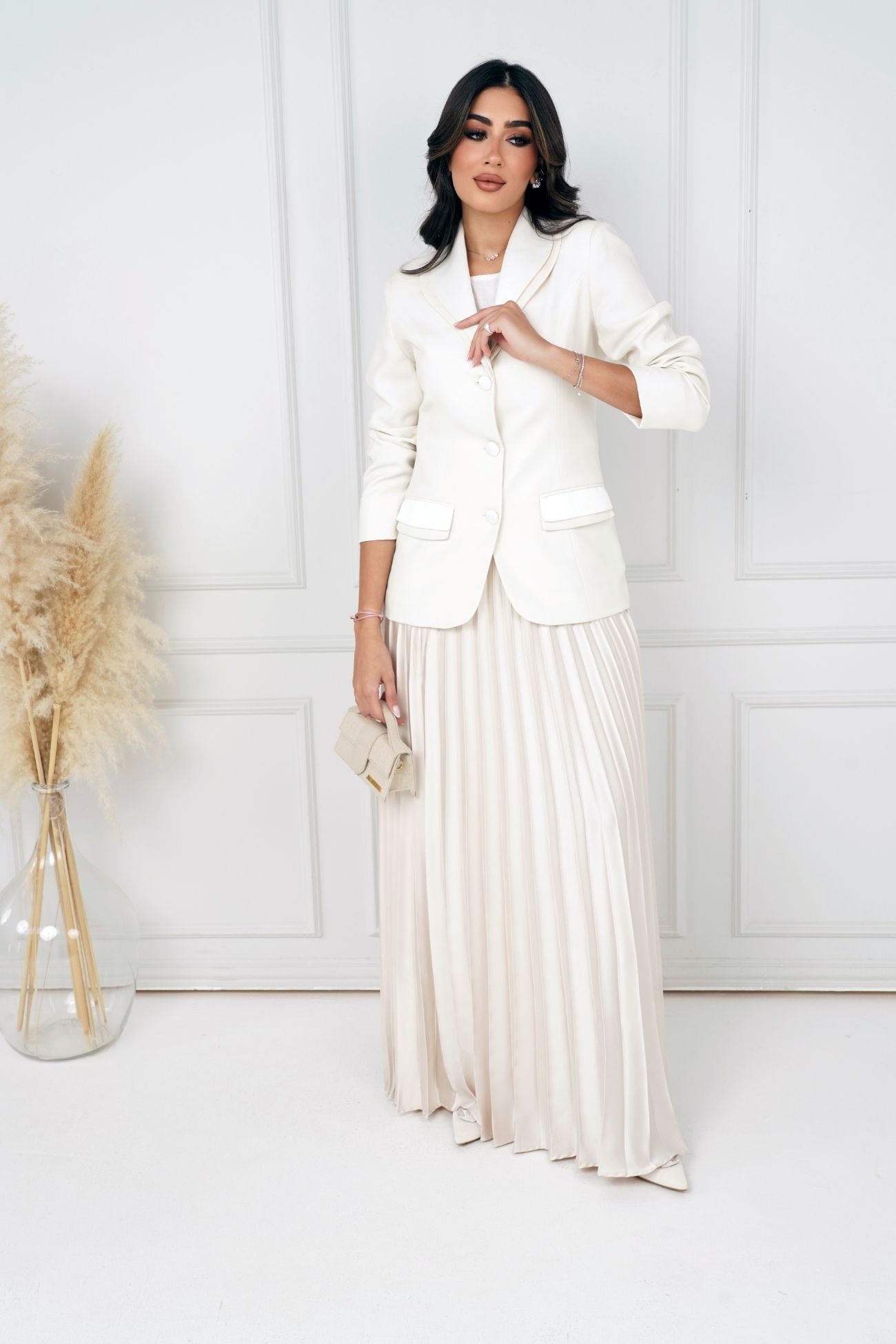 The off-white blazer and the shiny maxi pleated skirt