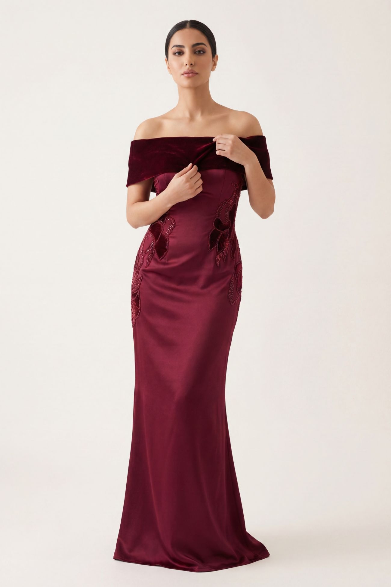 An elegant evening dress made of satin and velvet, featuring refined embroidery with velvet accents embellished with beads and crystals.